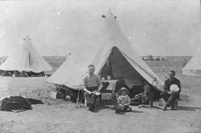 Men and a child in front of a tent during the North-West Resistance